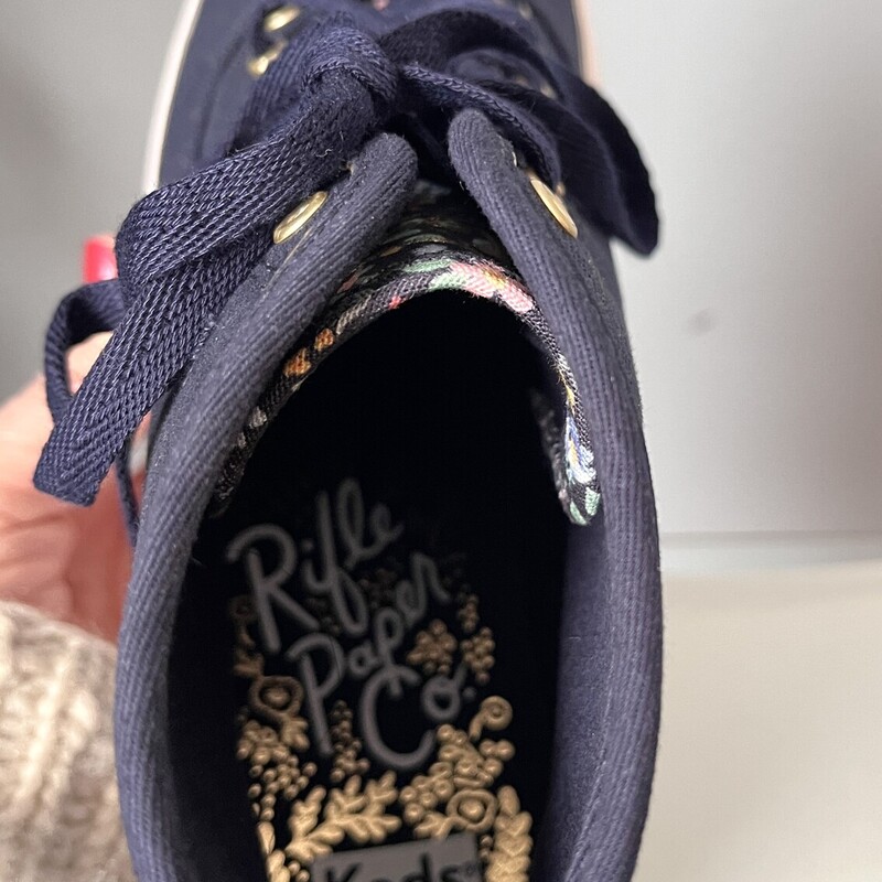 Irresistably pretty high top sneakers by keds, designed by the Rifle Paper Company.<br />
These are brand new.<br />
size 7<br />
They are sold out on the Keds Website.<br />
They have mid platforms and lug soles.<br />
Super wearable in Sold Navy Blue with floral accents<br />
If you would like me to ship them without the box for cheaper shipping, just let me know before you purchase and I'll adjust.<br />
<br />
thanks for looking!<br />
#82957