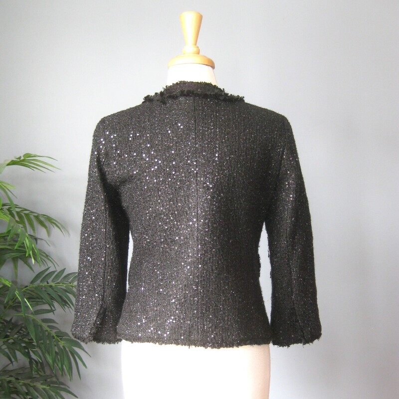 Michael Kors black day to evening or evening only jacket.<br />
This style is everlasting and this version has some modern twists.<br />
Flat sequind and snap closure<br />
fully lined<br />
four decorative fringed pocket flaps<br />
Acryic poly blend<br />
size 6<br />
flat measurements:<br />
shoulder to shoulder: 15<br />
armpit to armpit: 36<br />
length: 22.5<br />
underarm sleeve length: 12.25  they will reach aprox. mid forearm.<br />
this jacket is pre-owned but in like new condition!<br />
thanks for looking!<br />
#80834