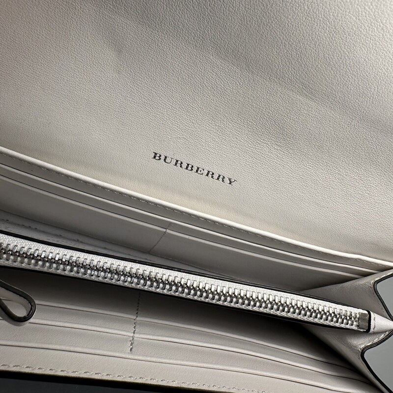 Burberry Peforated Logo White & Blue Wallet<br />
<br />
Dimensions:7.5L x4 H<br />
<br />
In very good condition. Some very minor marks on the leather. Light color transfer throughout the wallet.<br />
<br />
Does not come with original dust bag or box