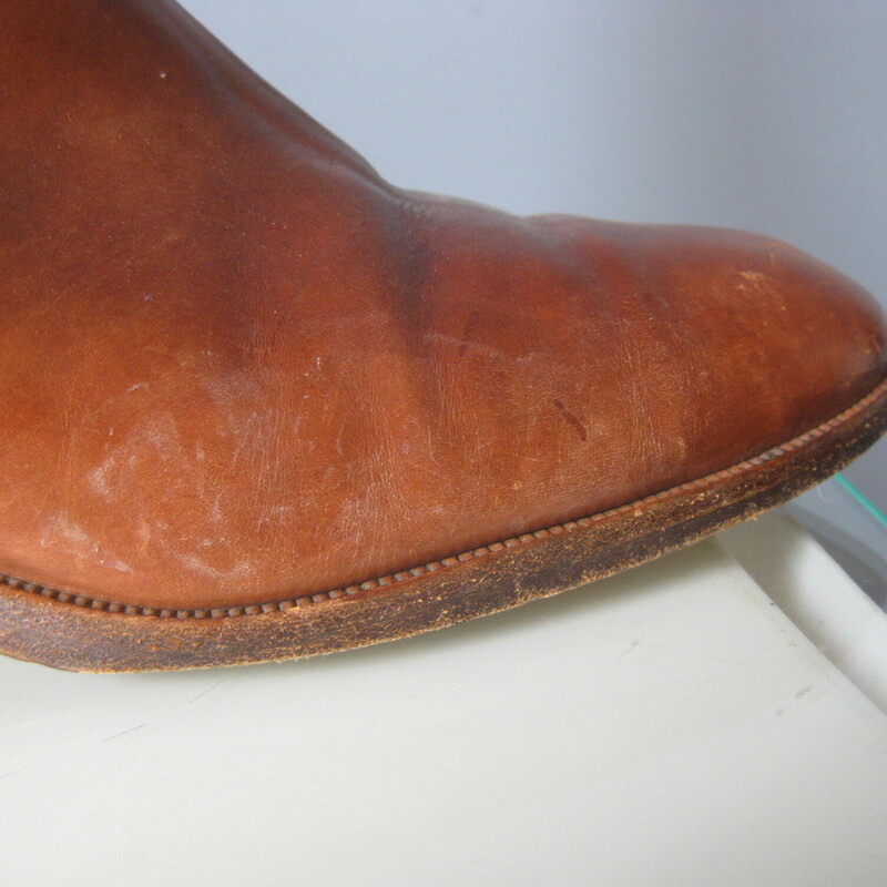 Leather Riding Boots, Brown, Size: 7.5<br />
Beautifully made pair of riding style boots in rich warm tan/brown leather.<br />
These do not have any branding inside or outside.<br />
they have leather outsoles.<br />
They have a thin leather strap detail around the ankles and a low stacked heel.<br />
NO ZIPPERS<br />
Size 7.5<br />
shaft: 15.5  from the top of the arch to the bottom of the heel<br />
width at calf: 6.25<br />
<br />
Good condition, well cared for with signs of use on the toes shaft and bottoms.<br />
Thanks for looking.<br />
#82954