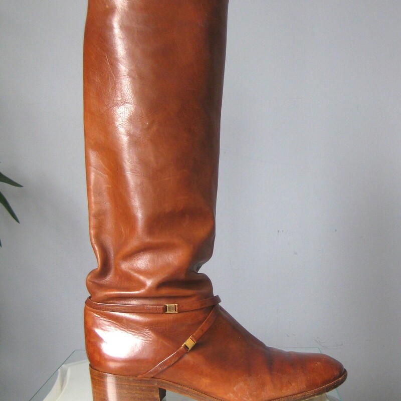 Leather Riding Boots, Brown, Size: 7.5<br />
Beautifully made pair of riding style boots in rich warm tan/brown leather.<br />
These do not have any branding inside or outside.<br />
they have leather outsoles.<br />
They have a thin leather strap detail around the ankles and a low stacked heel.<br />
NO ZIPPERS<br />
Size 7.5<br />
shaft: 15.5  from the top of the arch to the bottom of the heel<br />
width at calf: 6.25<br />
<br />
Good condition, well cared for with signs of use on the toes shaft and bottoms.<br />
Thanks for looking.<br />
#82954