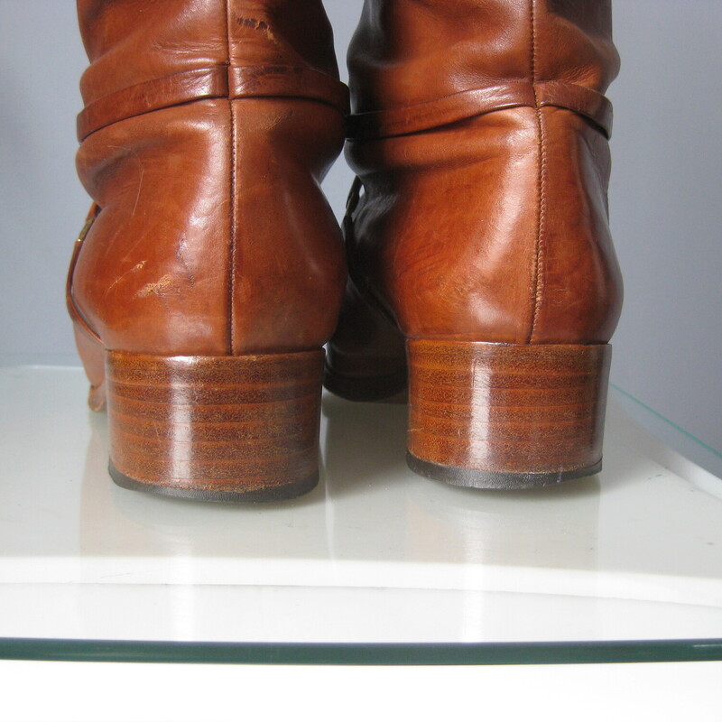 Leather Riding Boots, Brown, Size: 7.5<br />
Beautifully made pair of riding style boots in rich warm tan/brown leather.<br />
These do not have any branding inside or outside.<br />
they have leather outsoles.<br />
They have a thin leather strap detail around the ankles and a low stacked heel.<br />
NO ZIPPERS<br />
Size 7.5<br />
shaft: 15.5  from the top of the arch to the bottom of the heel<br />
width at calf: 6.25<br />
<br />
Good condition, well cared for with signs of use on the toes shaft and bottoms.<br />
Thanks for looking.<br />
#82954