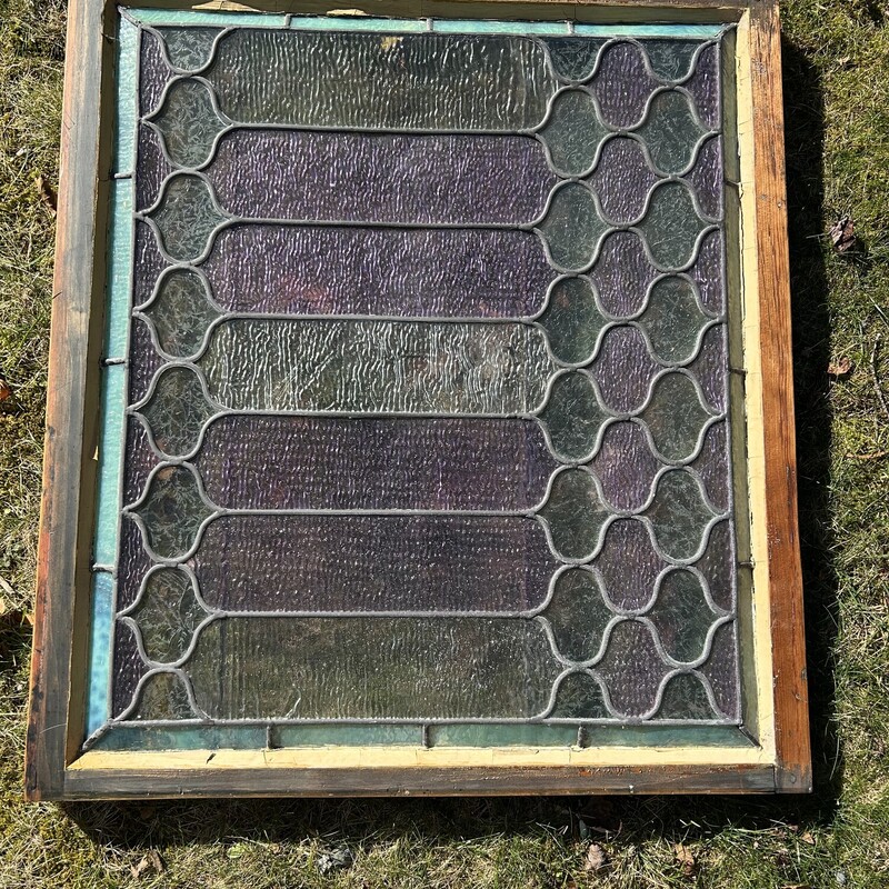 Stained Glass WIndow<br />
 Size: 32.5 X 30<br />
PRICE REDUCED!<br />
This is an original leaded stained glass window from a beautiful home.  All the glass is textured (translucent) allowing light to enter but it can not be seen through.  There is a beveled edge of a pale green with alternating panes of pale lavender and pale green.  The panes have differing texture patterns on them - some look like ice crystals that form on windows in the cold.  There is a wooden frame and two brass bars on the back side.  It is in very good condition.