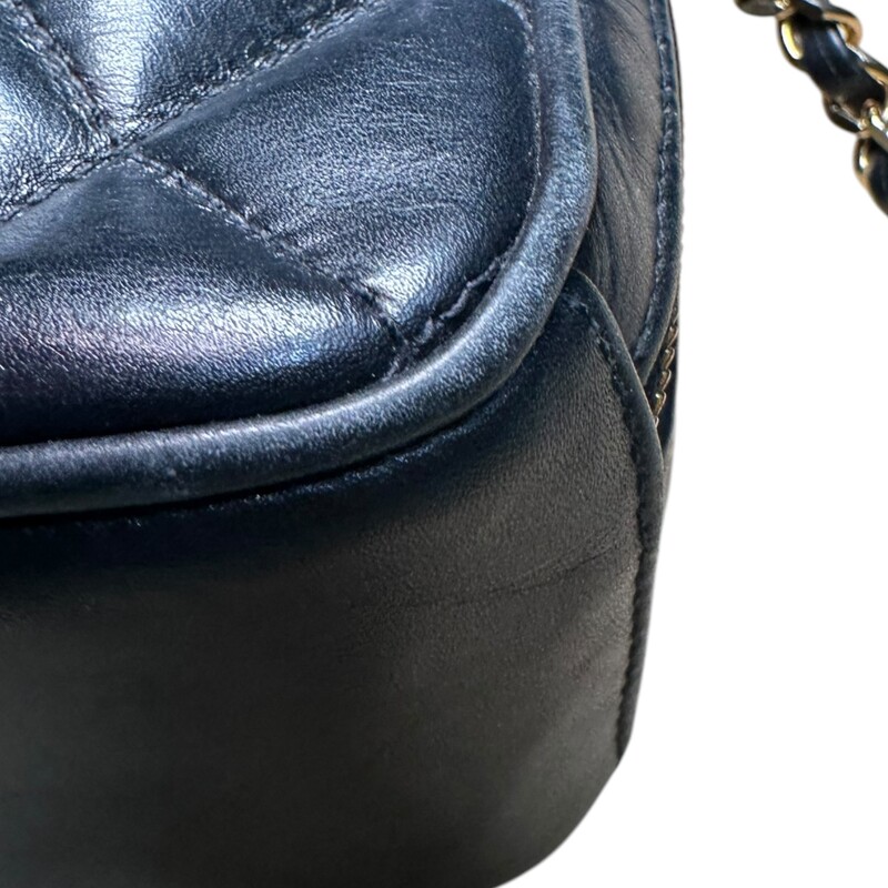 Chanel Camera Lambskin Black Handbag<br />
<br />
Entrupy Certificate provided<br />
<br />
Dimensions:<br />
9in x 6.5in x2in<br />
<br />
In very good condition. Tarnishing to the hardware. Light wear to the lambskin throughout the bag. Zipper pull on one interior pocket missing.<br />
<br />
Does not come with the original dust bag or box.