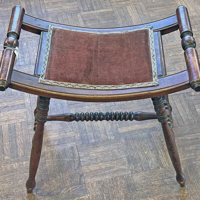 Antique Curved Stool
Size: 19 x 11 x 18
Solid stool with dk. red velvet top and recently replaced accent edging around velvet.
The design with the curved bench makes this a comfortable stool for to sit or to put your feet up on!