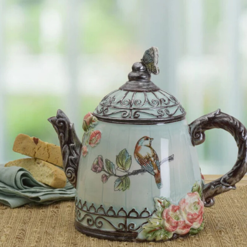 Fitz & Floyd English Garden Pitcher
Blue Silver Brown Ceramic
Size: 10x9H
This English Garden Teapot features blush tones of pink gracefully balanced against a sky of serenity blue, surrounding the artwork of song birds portrayed in inked-engraved style. A butterfly is perched on the teapot lid and will be stunning for serving your guests.
Crafted of Earthenware
Handwashing Recommended
Holds 60 ounces
Retail $80