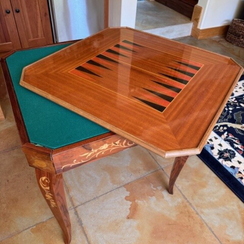 Noturno Intarsio Italian Game Table<br />
<br />
Size: 31Lx31Wx30T<br />
<br />
Notturno Intarsio refers to a style of inlaid wood game table, often featuring a variety of games and made in Sorrento Italy. These tables are know for their detailed marquetry and craftnanship. Games include Roulette, Chess, Backgammon and Cards