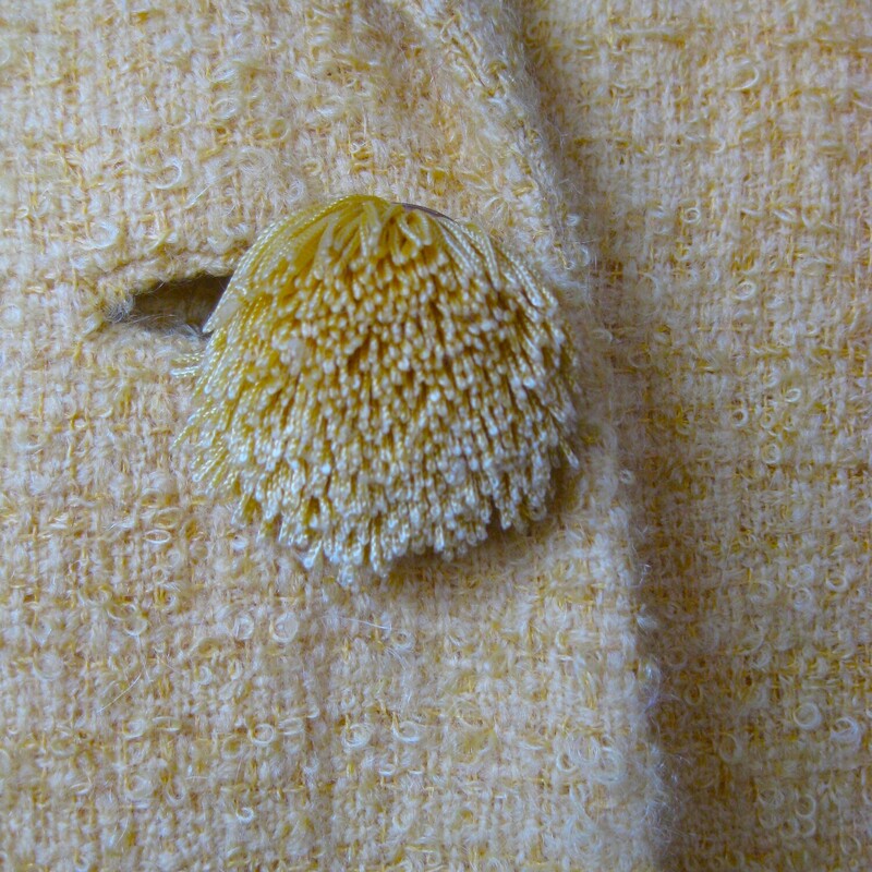 High quality cropped jacket in a fab yellow boucle.  It's from a boutique small department store and was made in the 1950s or 60s.<br />
The jacket closes with unique pom pom like buttons.<br />
I'll send it with the pretty rhinestone pin with which it came to me.<br />
<br />
The jacket couldn't be simpler and can be incorporated into a lot of different styles.<br />
Fully lined<br />
3/4 sleeves<br />
Should fit a modern size small.  Make sure you use the measurements below!<br />
 Here are the flat measurements, please double where appropriate:<br />
Armpit to Armpit: 18<br />
Width at Hem: 17<br />
Length: 19<br />
underarm sleeve length: 11 (aprox 3/4 length)<br />
Excellent vintage condition, no flaws<br />
thanks for looking!<br />
#84148