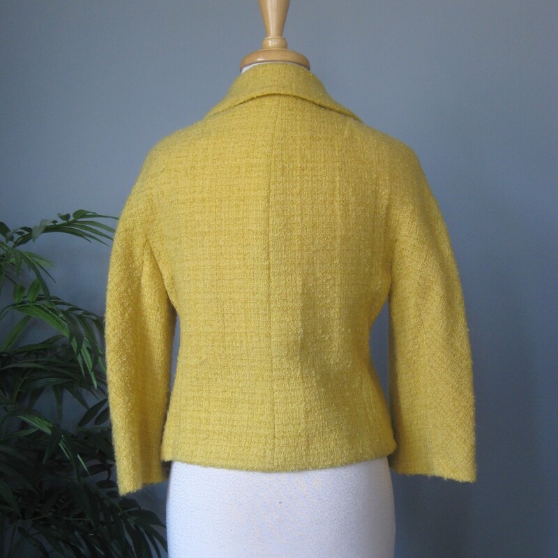 High quality cropped jacket in a fab yellow boucle.  It's from a boutique small department store and was made in the 1950s or 60s.<br />
The jacket closes with unique pom pom like buttons.<br />
I'll send it with the pretty rhinestone pin with which it came to me.<br />
<br />
The jacket couldn't be simpler and can be incorporated into a lot of different styles.<br />
Fully lined<br />
3/4 sleeves<br />
Should fit a modern size small.  Make sure you use the measurements below!<br />
 Here are the flat measurements, please double where appropriate:<br />
Armpit to Armpit: 18<br />
Width at Hem: 17<br />
Length: 19<br />
underarm sleeve length: 11 (aprox 3/4 length)<br />
Excellent vintage condition, no flaws<br />
thanks for looking!<br />
#84148