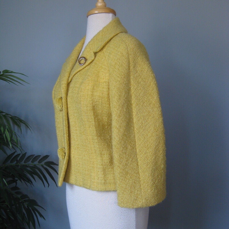 High quality cropped jacket in a fab yellow boucle.  It's from a boutique small department store and was made in the 1950s or 60s.<br />
The jacket closes with unique pom pom like buttons.<br />
I'll send it with the pretty rhinestone pin with which it came to me.<br />
<br />
The jacket couldn't be simpler and can be incorporated into a lot of different styles.<br />
Fully lined<br />
3/4 sleeves<br />
Should fit a modern size small.  Make sure you use the measurements below!<br />
 Here are the flat measurements, please double where appropriate:<br />
Armpit to Armpit: 18<br />
Width at Hem: 17<br />
Length: 19<br />
underarm sleeve length: 11 (aprox 3/4 length)<br />
Excellent vintage condition, no flaws<br />
thanks for looking!<br />
#84148