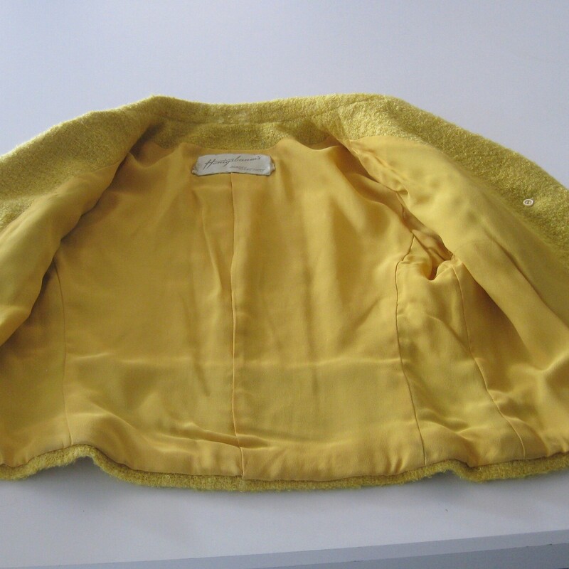 High quality cropped jacket in a fab yellow boucle.  It's from a boutique small department store and was made in the 1950s or 60s.<br />
The jacket closes with unique pom pom like buttons.<br />
I'll send it with the pretty rhinestone pin with which it came to me.<br />
<br />
The jacket couldn't be simpler and can be incorporated into a lot of different styles.<br />
Fully lined<br />
3/4 sleeves<br />
Should fit a modern size small.  Make sure you use the measurements below!<br />
 Here are the flat measurements, please double where appropriate:<br />
Armpit to Armpit: 18<br />
Width at Hem: 17<br />
Length: 19<br />
underarm sleeve length: 11 (aprox 3/4 length)<br />
Excellent vintage condition, no flaws<br />
thanks for looking!<br />
#84148