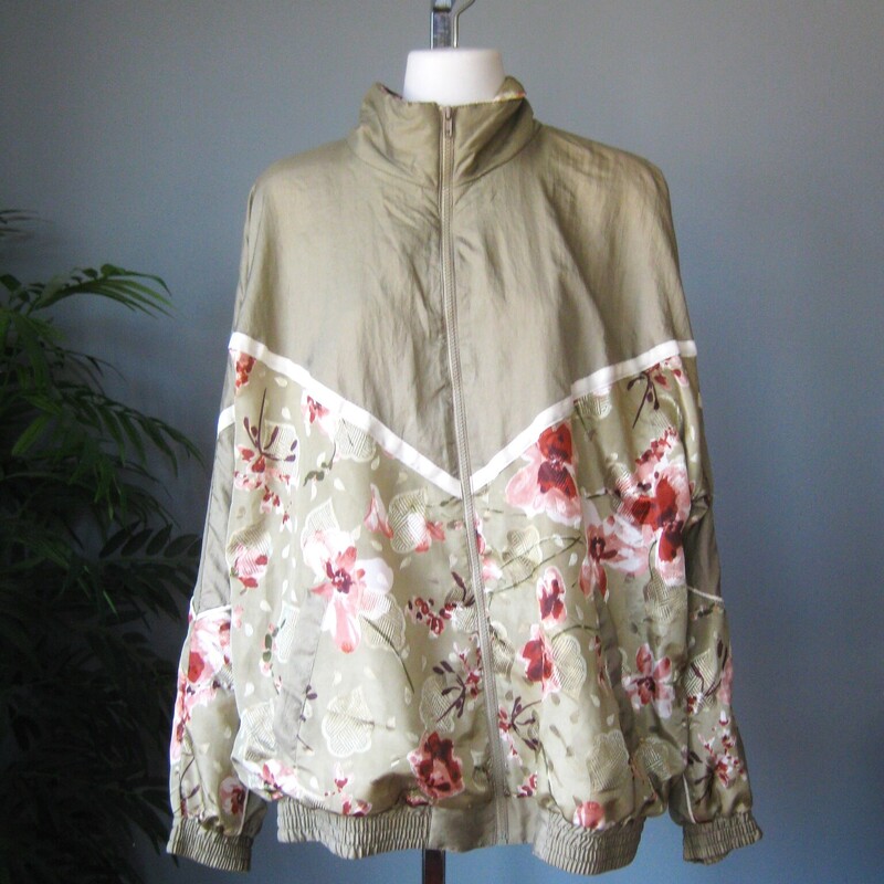 Vtg NOS Nylon Windbreaker, Green, Size: Large<br />
Fun 1980s or 1990s windbreaker track jacket in sage green with pink and white florals<br />
zip front, zip pockets<br />
elasticized cuff and waist with plent of snap<br />
crinkly nylon shell<br />
cotton/poly blend lining<br />
by Lauren Brooke made in Pakistan<br />
New with tags, never worn.<br />
<br />
Marked size Large, fit is supposed to be oversized<br />
flat measurements:<br />
armpit to armpit: 28<br />
width at hem, unstretched: 21<br />
underarm sleeve length: 18<br />
length: 28.5<br />
<br />
thanks for looking!<br />
#81286