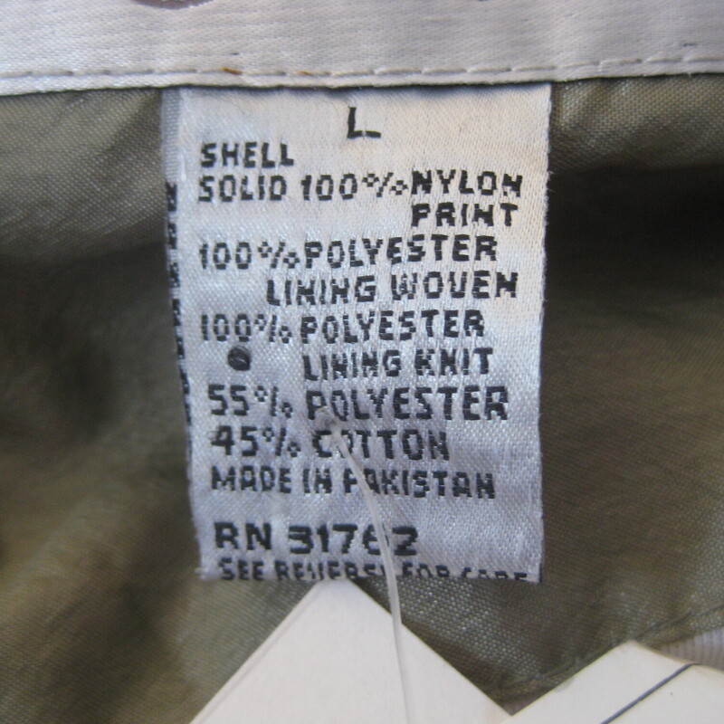 Vtg NOS Nylon Windbreaker, Green, Size: Large<br />
Fun 1980s or 1990s windbreaker track jacket in sage green with pink and white florals<br />
zip front, zip pockets<br />
elasticized cuff and waist with plent of snap<br />
crinkly nylon shell<br />
cotton/poly blend lining<br />
by Lauren Brooke made in Pakistan<br />
New with tags, never worn.<br />
<br />
Marked size Large, fit is supposed to be oversized<br />
flat measurements:<br />
armpit to armpit: 28<br />
width at hem, unstretched: 21<br />
underarm sleeve length: 18<br />
length: 28.5<br />
<br />
thanks for looking!<br />
#81286