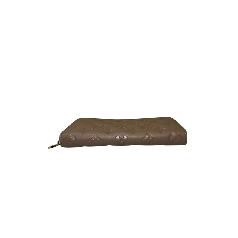 Louis Vuitton Coussin Taupe  Zippy Wallet<br />
<br />
Date Code: Microchip<br />
<br />
Dimensions:Base length:<br />
7.75 in<br />
Height: 4 in<br />
Width: 0.75 in<br />
<br />
In excellent condition.Some minor scratches on hardware.<br />
<br />
Does come with original dust bag. No box