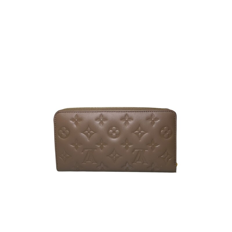 Louis Vuitton Coussin Taupe  Zippy Wallet<br />
<br />
Date Code: Microchip<br />
<br />
Dimensions:Base length:<br />
7.75 in<br />
Height: 4 in<br />
Width: 0.75 in<br />
<br />
In excellent condition.Some minor scratches on hardware.<br />
<br />
Does come with original dust bag. No box