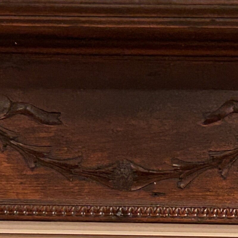 Antique Carved Wall Shelf,
Size: 42x9x10
Beautiful antique wall shelf with 3 D hangers. Brackets are detailed with federal fluting. Backboard has a carved ribbo design.  Sturdy and good size shelf - perfect for display.