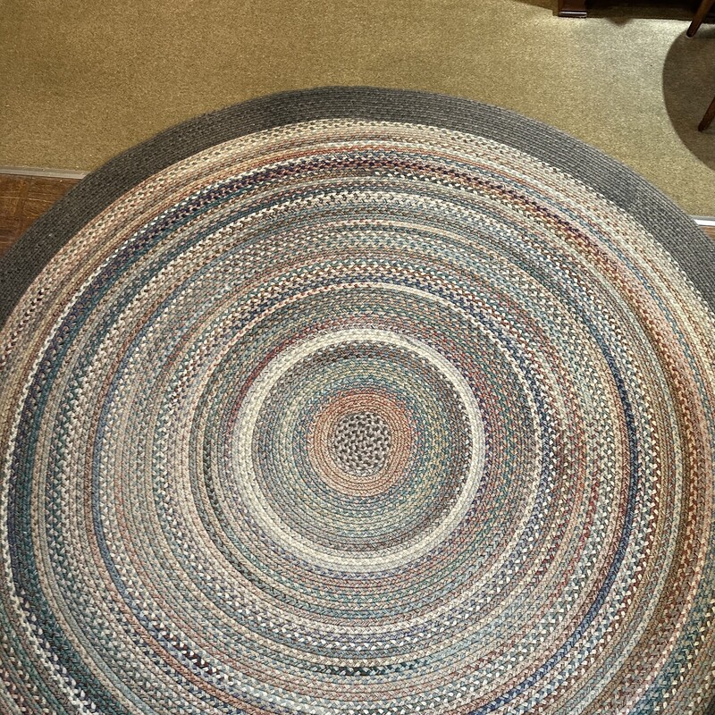 90 In. Wool Braided Rug
90round - 100% wool
Nice earth tones of green, beige brown and light orange
surround this braided rug.  It is in very good condition with one small spot of wear on an edge (as shown in photo).