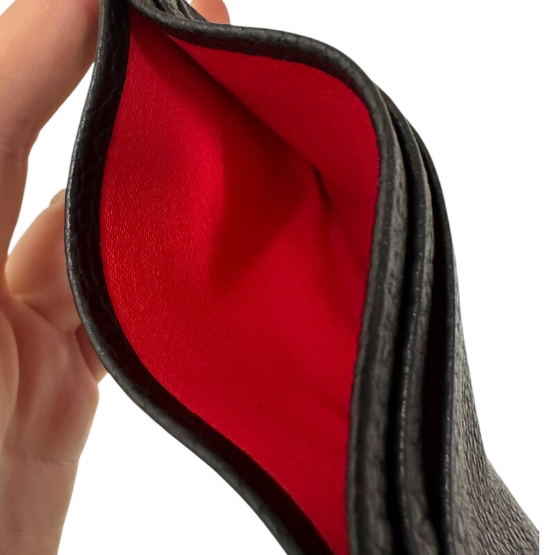 Christian Louboutin Kios Card Holder Leather  Black<br />
<br />
Dimensions: 4 L x 3 H inches<br />
<br />
In very good condition. Very faint scratches on the rubber.<br />
<br />
Comes with original dust bag and box.