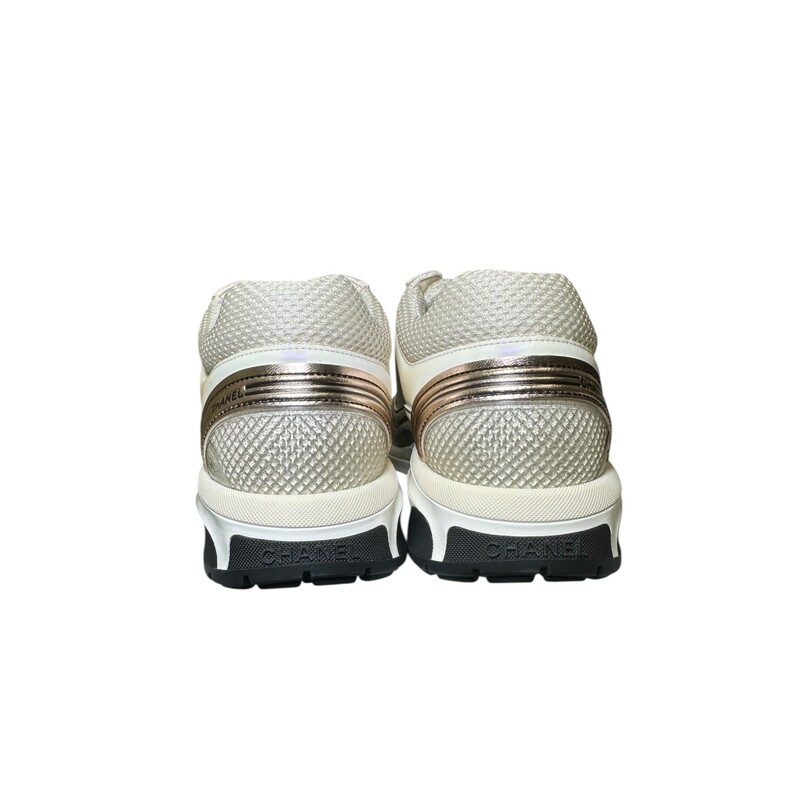 Chanel Fabric Laminated Calfskin Stretch CC Sneakers Ivory White Silver 23A G45077B13308<br />
<br />
Size 37.5<br />
<br />
Code: W G45077<br />
<br />
In excellent condition. New in Box.<br />
<br />
Comes with the original dust bag and box.