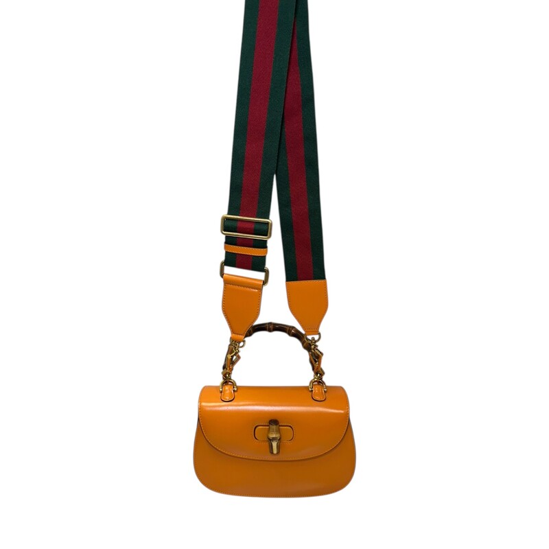 Gucci Bamboo 1947 Top Handle Orange Small<br />
<br />
Syle Code: 675797 498879<br />
<br />
Dimensions:<br />
Length: 8.25 in<br />
Height: 6 in<br />
Width: 2.75 in<br />
Drop: 4.25 in<br />
Drop: 22 in<br />
Drop: 21.75 in<br />
<br />
In excellent condition. Does not come with the leather strap, comes with the web canvas strap.<br />
<br />
Does not come with the original dust bag or box.