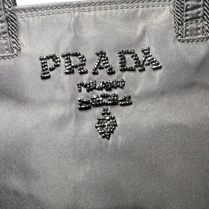 Prada Beaded Satin Sequin Tote Bag<br />
<br />
Factory code:26<br />
<br />
Dimensions: 9L x 9H inches<br />
<br />
In very good condition. Some faint marks on the nylon.<br />
<br />
Comes with original dust bag. No box.