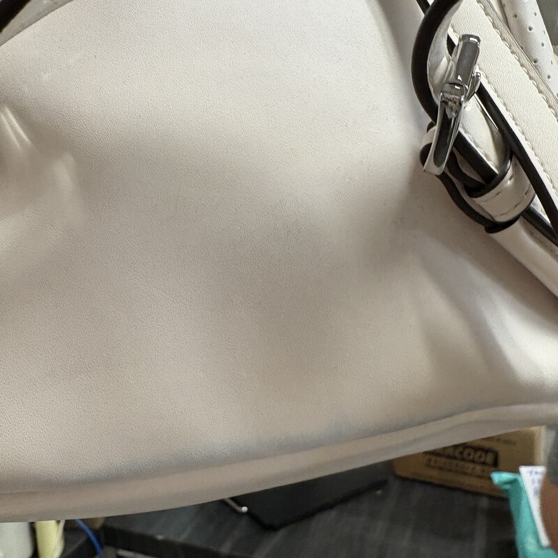 White Michael Kors Backpack has a faint blue line on bottom back