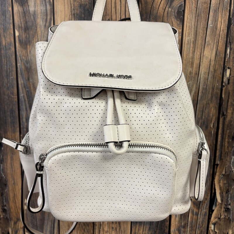 White Michael Kors Backpack has a faint blue line on bottom back