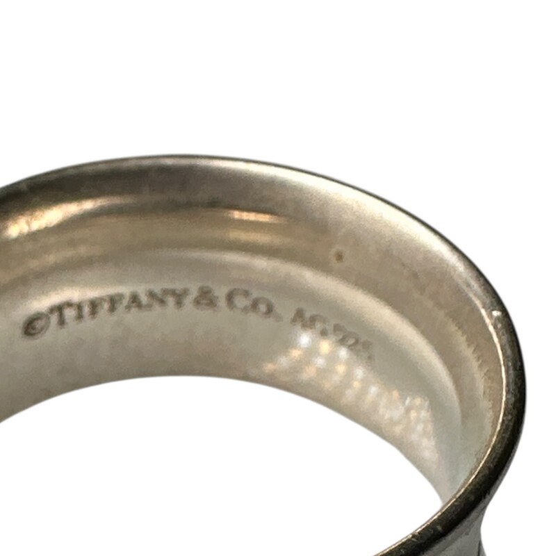 Tiffany & Co 1837 Wide Band Ring<br />
<br />
Sterling Silver<br />
<br />
Size 10.5<br />
<br />
In very good condition. Faint scratching.<br />
<br />
Does not come with original dusrt bag or box.