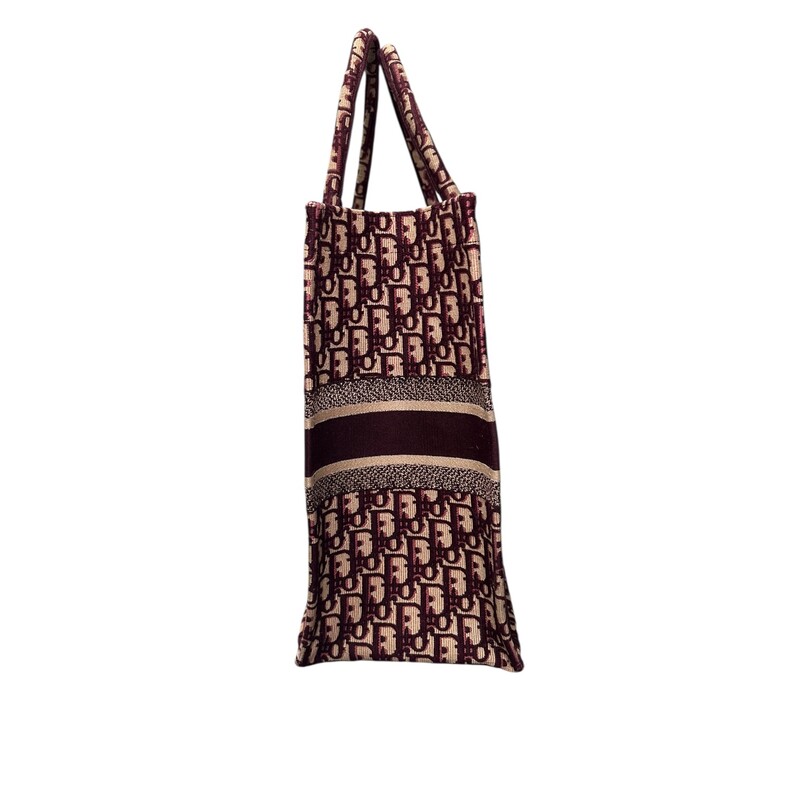 Dior Oblique Book BurgundyTote<br />
<br />
Date Code:50-MA-0168<br />
<br />
Dimensions: 17 L x 13 H inches<br />
<br />
In very good condition. Some minor corner wear.<br />
<br />
Does not come with original dust bag or box.