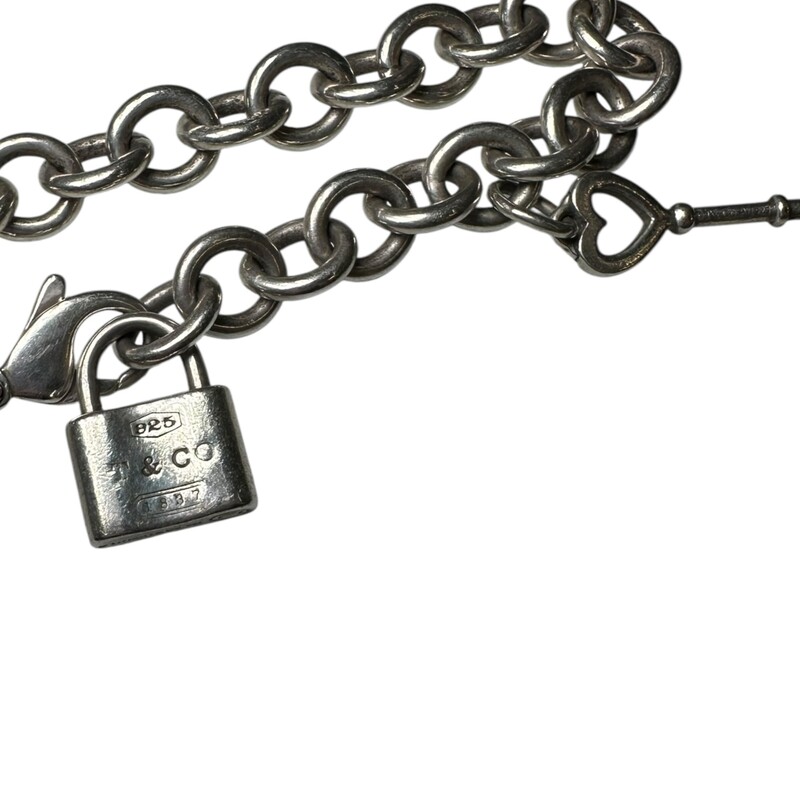 Tiffany & Co Key And Lock Silver Bracelet<br />
<br />
Sterling Silver<br />
<br />
In very good condition. Some minor scratches on the hardware.<br />
<br />
Does not come with original dust bag or box.