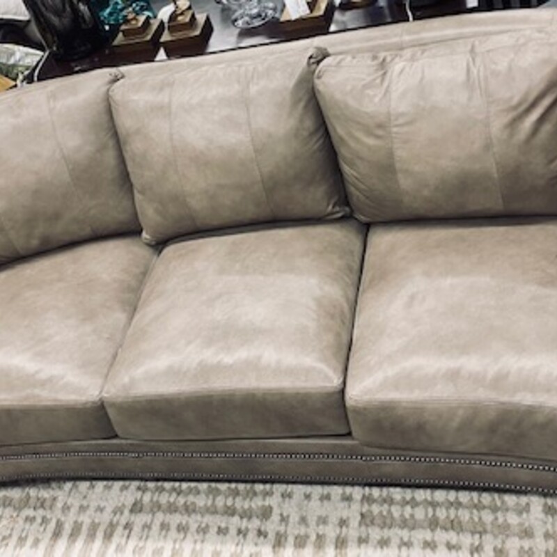 Bradington Young Leather
Pewter Tan  Leather Silver Nailheads
Light Brown Wood Legs
Size: 91x41x35H
Premium grade leather slightly curved sofa with loose back and a spring down seat. This style employs double-cone coil springs that are eight-way hand tied and then secured to polypropylene webbing that is reinforced with steel banded grids for additional support.
Retail $7620  Matching Sofa Sold Separately