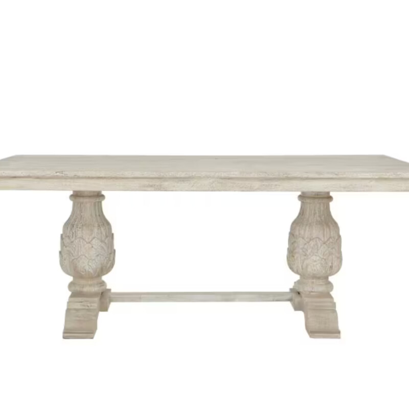 HDC Kingsley Dining Table
Distress White Mango Wood
Size: 80x40x30H
The Kingsley Pedestal Rectangle Dining Table exemplifies the beauty of mango wood furniture, with warm tonal variations and beautiful grain. The generous top of this rectangular dining table rests on a pair of intricately carved pedestals. Each pedestal features an intricate leaf design at the base and slim fluting as the pedestal narrows upward. Wide feet and a stable crossbar give this solid wood dining room table extra sturdiness. Finely crafted with a rustic, artisan aesthetic, this pedestal table grounds your dining room in timeless elegance.