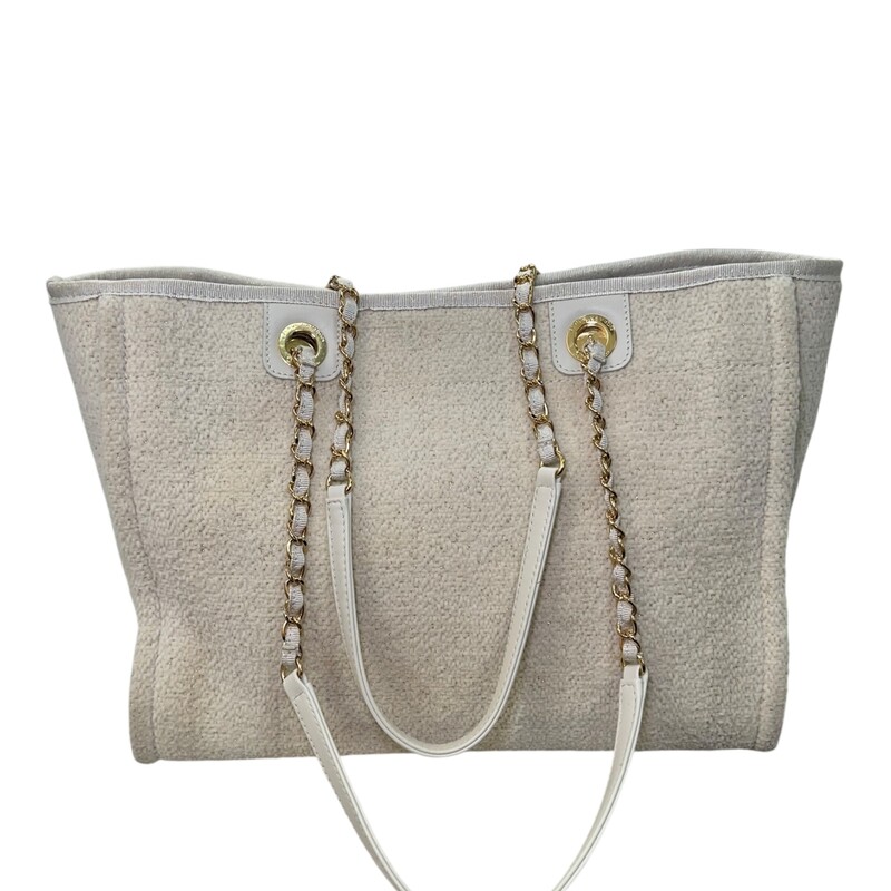 Chanel Deauville Tweed Cream Gold Glitter Tote<br />
<br />
Serial Code:2829****<br />
<br />
Dimensions:13 L x 11 H inches<br />
<br />
In good condition. Some discoloration and marks on the back of the bag.<br />
<br />
Comes with the original dust bag. No box.