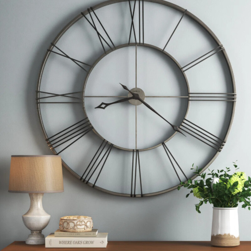 Howard Miller Wall Clock
Grey Black Silver Metal
Size: 49x49
An hour and minute hands are finished in charcoal black and an open fret-cut diamond style.
Designed to last: Quality materials that stand the test of time allow this large wall clock to remain a central part of the home for decades to come. It’s made with sturdy wrought iron finished in brushed aged nickel. The old-world effect is further amplified by black Roman numerals applied with a charcoal black finish. Both the hour and minute hands boast the same dark hue, while the open fret-cut diamond style workmanship contributes to its unblemished look.
Quartz movement: The quartz, battery-operated movement requires 1 AA battery (not included)