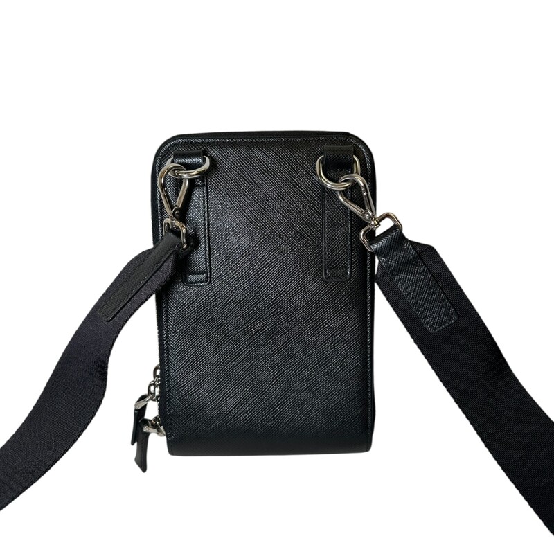 Prada Smart Phone Saffiano Black Leather Crossbody

Code: 12

Dimensions:
4.5inW x 7inH x 1inD

In very good condition. Light piling to the edge by the zipper.

Does not come with the original dust bag or box.