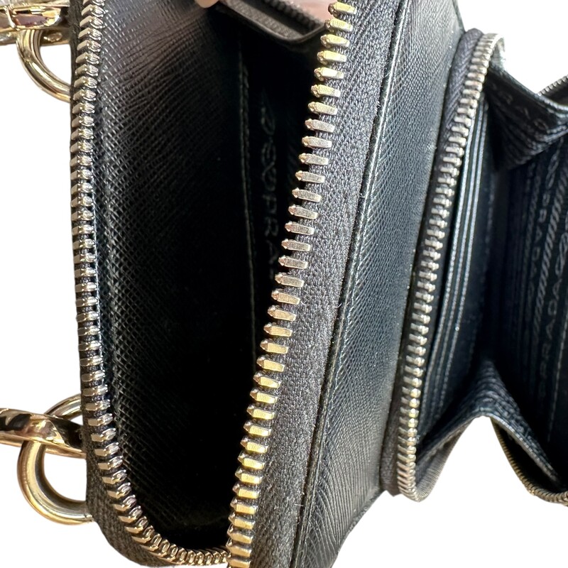 Prada Smart Phone Saffiano Black Leather Crossbody<br />
<br />
Code: 12<br />
<br />
Dimensions:<br />
4.5inW x 7inH x 1inD<br />
<br />
In very good condition. Light piling to the edge by the zipper.<br />
<br />
Does not come with the original dust bag or box.
