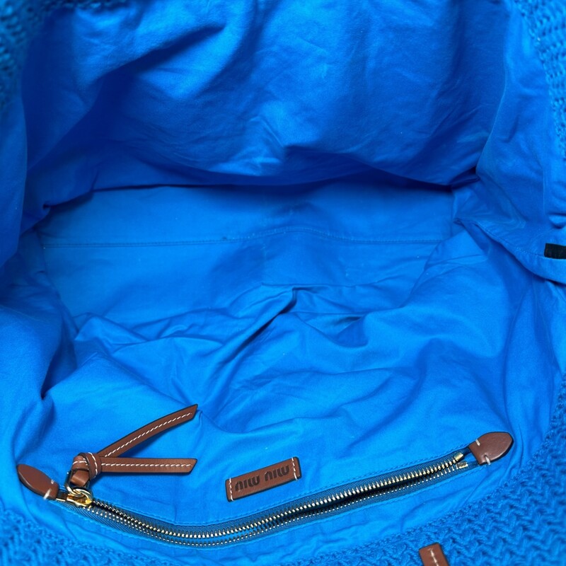 Miu Miu Raffia Effect Woven Tote<br />
<br />
Dimensions: 18 L x 14 H inches<br />
<br />
In very good condition. Some marks on the bottom of the bag.<br />
<br />
Does not come with the original dust bag or box.