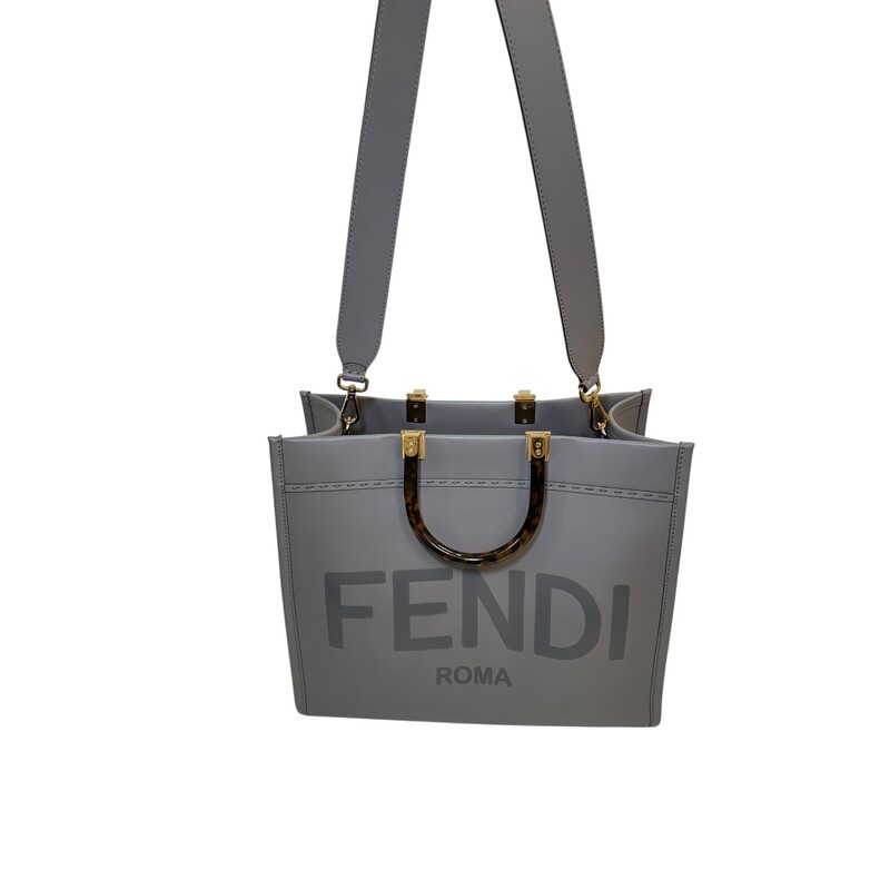 Fendi Sunshine Grey Leather Tote With Strap<br />
<br />
Style Code:98H386 ABVI2212085<br />
<br />
Dimensions: 14 L x 12 H inches<br />
<br />
In very good condition. Some scratching on the hardware.<br />
<br />
Comes witrh the original dust bag and box.
