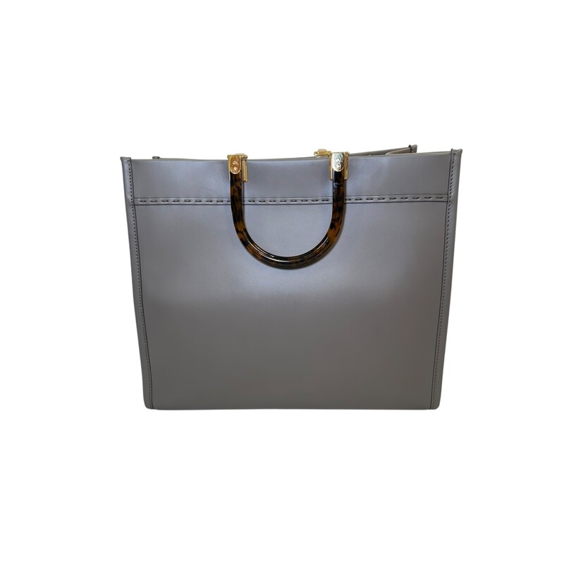 Fendi Sunshine Grey Leather Tote With Strap<br />
<br />
Style Code:98H386 ABVI2212085<br />
<br />
Dimensions: 14 L x 12 H inches<br />
<br />
In very good condition. Some scratching on the hardware.<br />
<br />
Comes witrh the original dust bag and box.