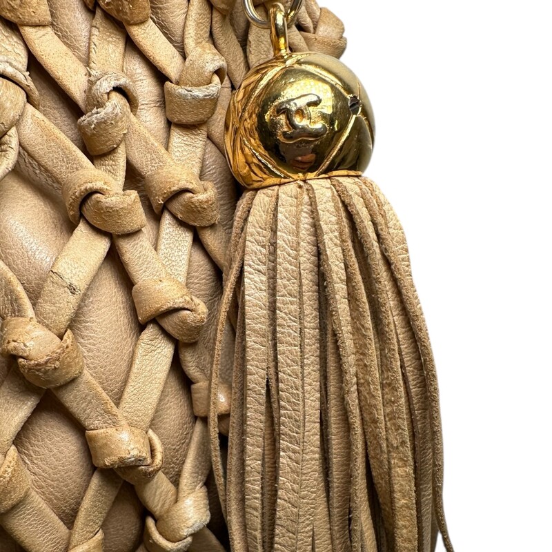 Chanel Woven Leather Tassle Bucket Bag<br />
<br />
Dimensions: 9 L x 9 H inches<br />
<br />
In very good condition. Some minor scuffing of the leather.  Some interior pen marks.<br />
<br />
Does not come with the original dust bag or box.