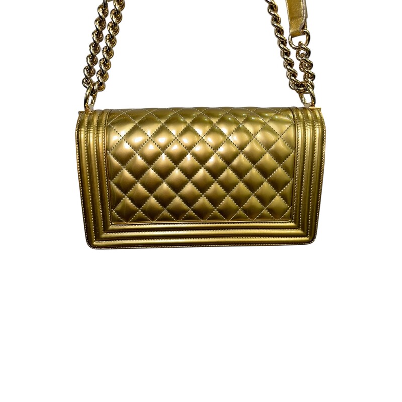 Chanel Boy Patent Gold Medium Handbag<br />
<br />
Date Code: 1973****<br />
<br />
Dimensions:<br />
Length: 9.75 in<br />
Width: 3 in<br />
Height: 5.5 in<br />
Drop: 21 in<br />
Drop: 12 in<br />
<br />
In very good condition. Light scuffsing to the hardware and corners of handbag. Crack on the inside of the strap and leather torn. Strap is still in working condition.<br />
<br />
Does not come with the original dust bag or box.