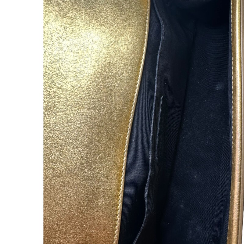 Chanel Boy Patent Gold Medium Handbag<br />
<br />
Date Code: 1973****<br />
<br />
Dimensions:<br />
Length: 9.75 in<br />
Width: 3 in<br />
Height: 5.5 in<br />
Drop: 21 in<br />
Drop: 12 in<br />
<br />
In very good condition. Light scuffsing to the hardware and corners of handbag. Crack on the inside of the strap and leather torn. Strap is still in working condition.<br />
<br />
Does not come with the original dust bag or box.