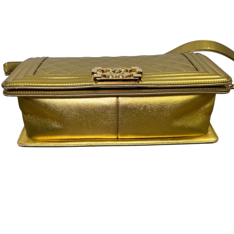 Chanel Boy Patent Gold Medium Handbag<br />
<br />
Date Code: 1973****<br />
<br />
Dimensions:<br />
Length: 9.75 in<br />
Width: 3 in<br />
Height: 5.5 in<br />
Drop: 21 in<br />
Drop: 12 in<br />
<br />
In very good condition. Light scuffsing to the hardware and corners of handbag. Crack on the inside of the strap and leather torn. Strap is still in working condition.<br />
<br />
Does not come with the original dust bag or box.