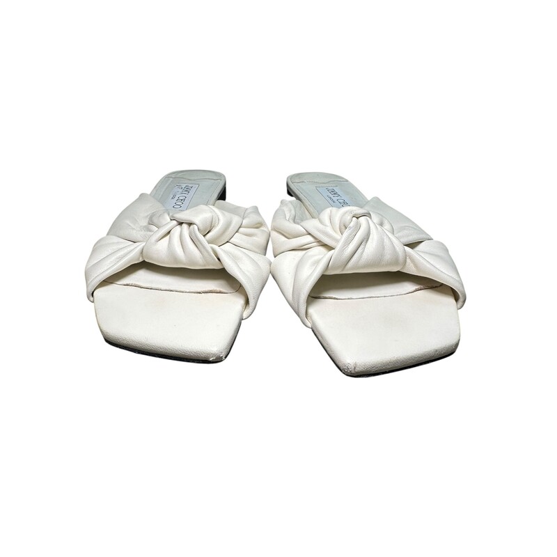 Jimmy Choo Nappa Leather White Sandals<br />
<br />
Size 37<br />
<br />
In good condition. Wear to the front leather toe and throughout the shoe. Mark on bottom of shoes.<br />
<br />
Does not come with the original dust bag or box.