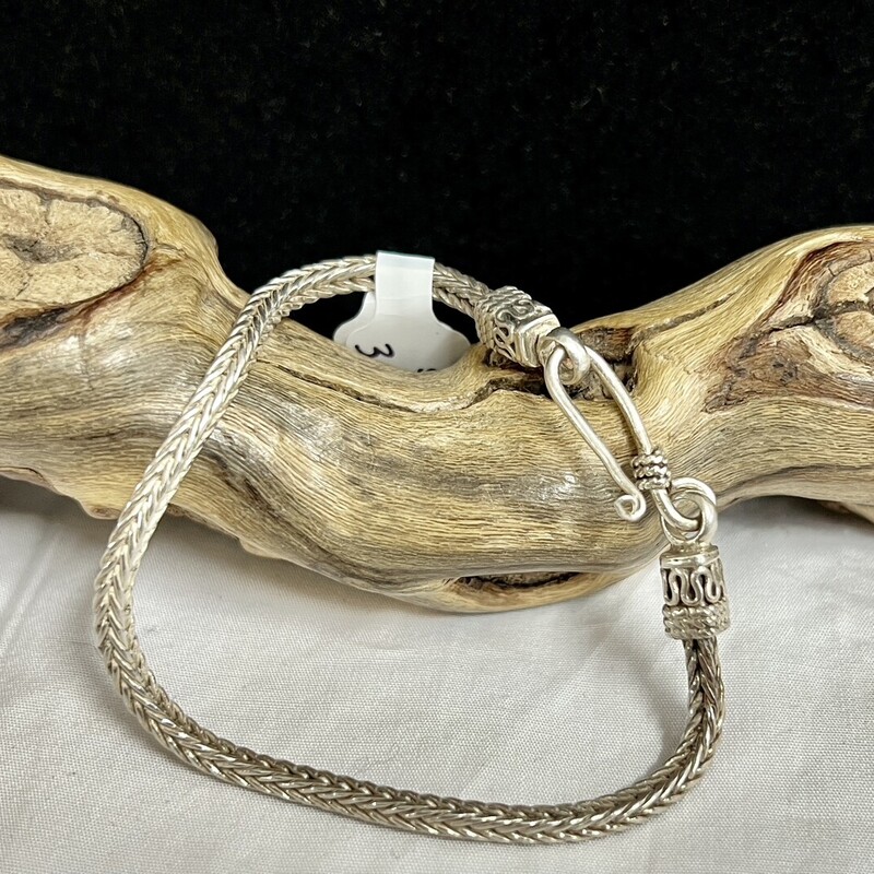 Silver tone weave bracelet.