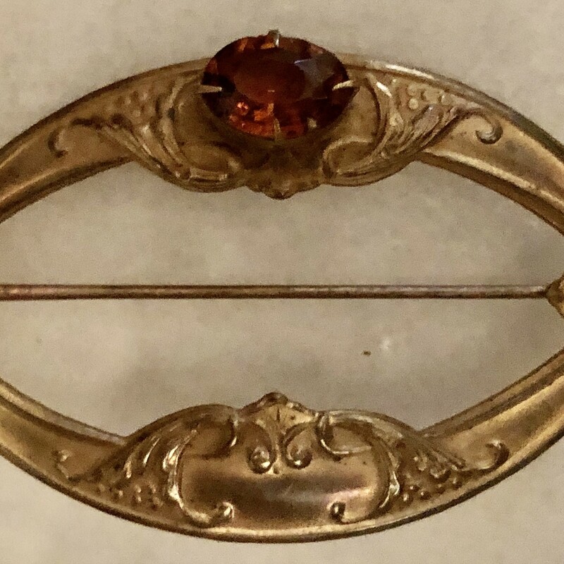 Victorian Brass on copper Sash Pin with amber glass bezel set cabochon.  Original c-clasp. Size: 3in X  2in