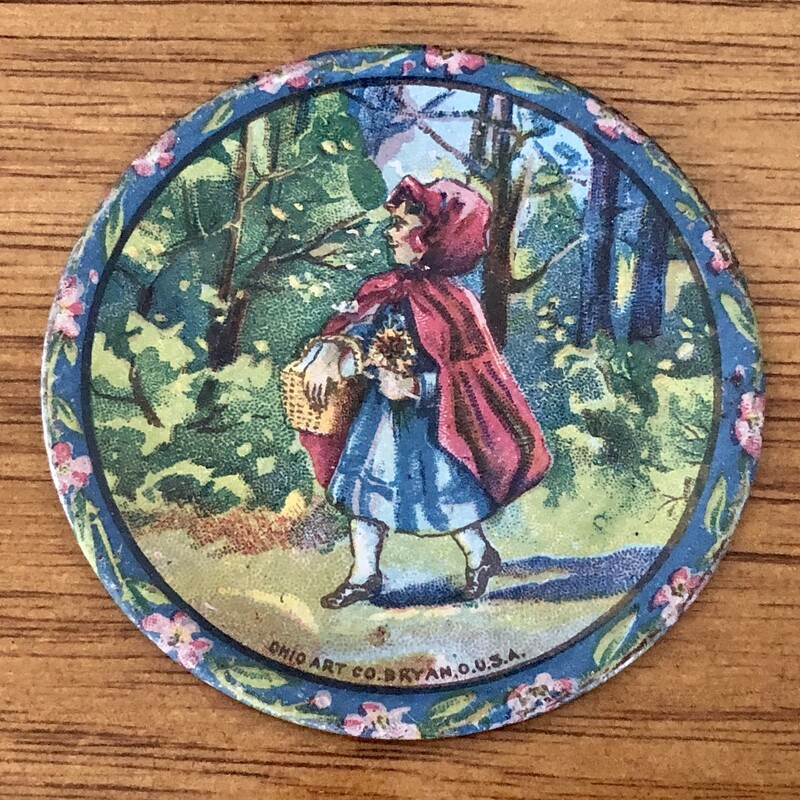 Ohio Art Tin Litho Little Red Riding Hood Tea Set c.1930s.<br />
- 1 Large plate 6 1/8 in diameter<br />
-3  Small plates 2 3/4 in diameter<br />
- 4  2 inch cup with handles<br />
- 1 2 1/4 teaot with lid<br />
This set has been used and has paint loss consistent with a 1930s set.