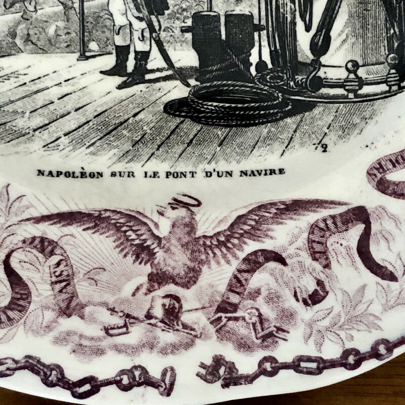 French Napoleon Commerative Assiettes Parlantes Plate. c.1840s Napoleon Sur Le Pont D'un Navire<br />
Assiettes Parlantes, or talking plates, are French transferware plates with sayings on them. The most collectible illustrate the life of a French hero such as the plates depicting Napoleon. Really unusual to find in purple. 8.