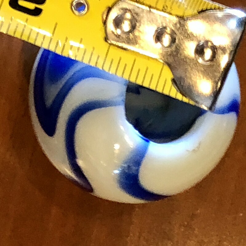 Original Acro Agate Co. blue swirl glass Gear Shift Knob c.1920-30s. The knob has a blue and white swirl design throughout with a hole cut out of the bottom to place onto shift stick. This hole measures 3/4in in diameter & has flea bite chip out of the bottom edge clearly visible in the photo. The knob has a smooth finish and is perfectly round.  Measures 1 3/4in in diameter and 1 3/4in tall.
Great addition for the marbles or automotive collector.
Will ship priority mail.