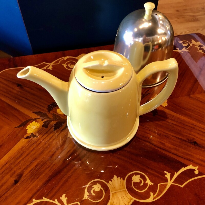 Vintage c. 1950s HALL China teapot in canary yellow.<br />
It has an aluminum cosy with felt lining so your last cup<br />
of tea is as hot as the first!  Teapot is heavy pottery with a built-in strainer at the base of the spout. It is marked on the bottom with the Hall trademark. Measures 7 1/8 inches high with the cover. Very nice design., Excellent condition, no chips, cracks, or repairs. The metal cover shows light surface wear.